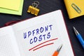 Business Concept Meaning UPFRONT COSTS With Inscription On The Piece Of Paper. AnÃÂ upfront CostÃÂ is An Initial Sum Of Money Owed